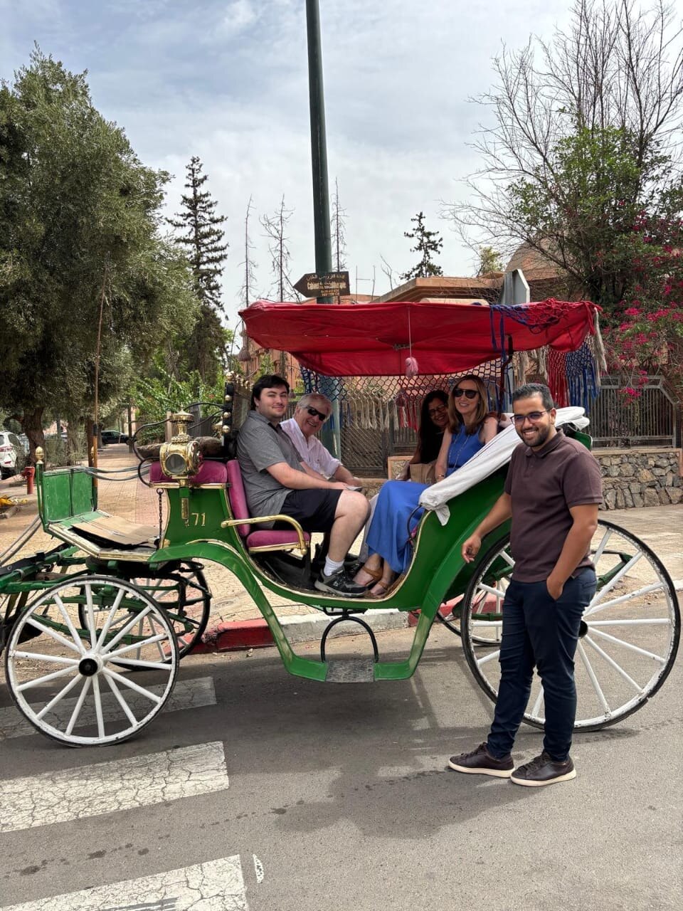 Ayoub hosting guests on a traditional carriage ride in Marrakech
